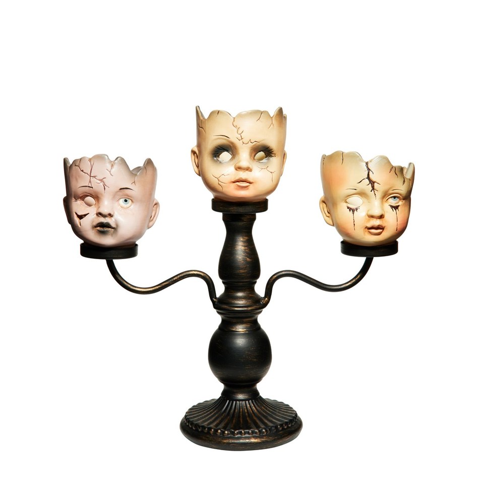 Three doll-head candle cups on a gothic candelabra