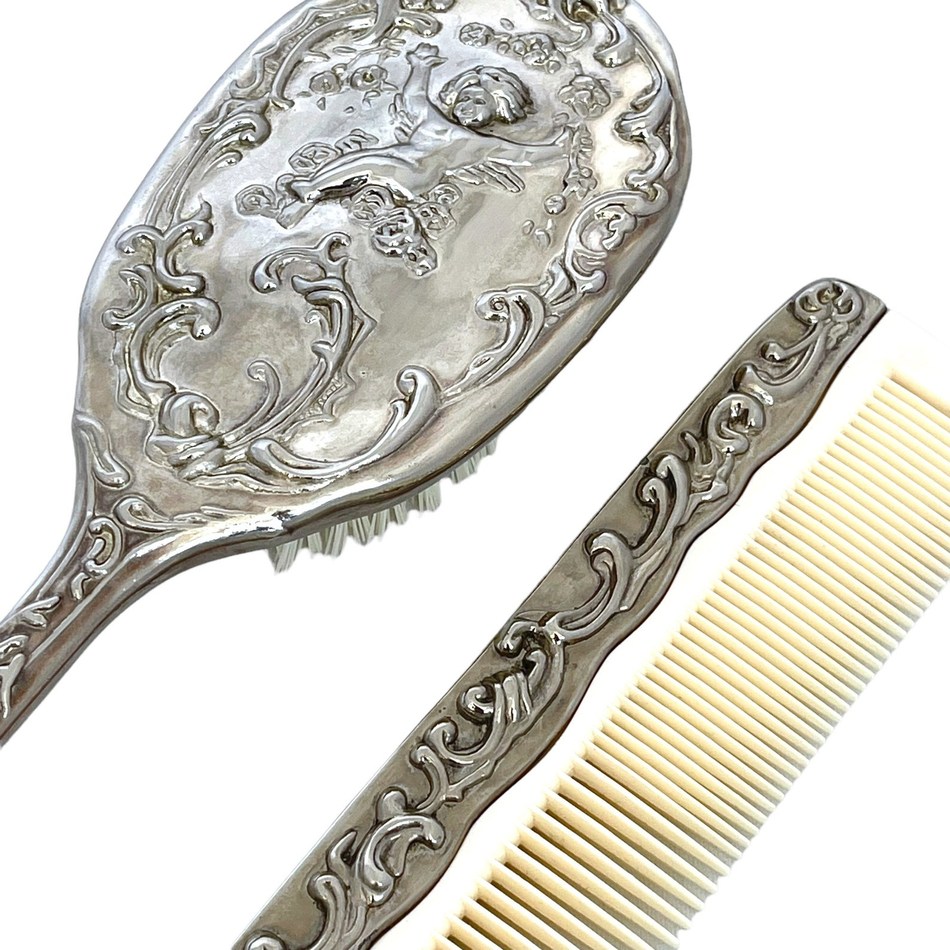 Real vintage silver-plated cherub brush and cream-toothed comb