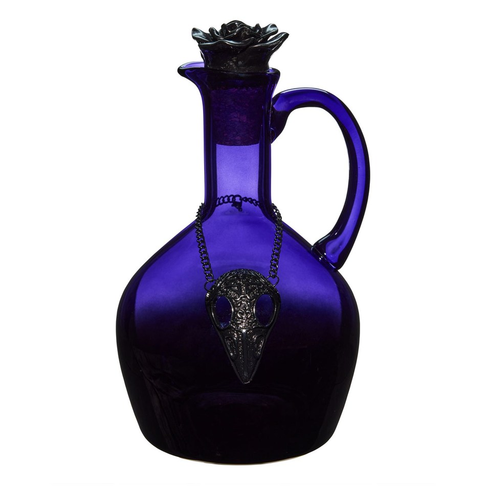 Purple glass decanter with a curved handle and black rose stopper